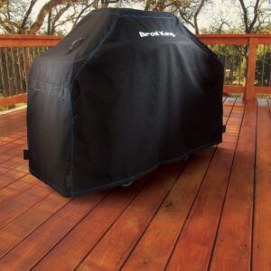 Broil King Grill Cover 68492 sitting on a wood patio